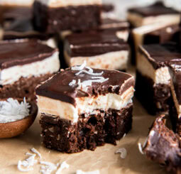 Coconut brownies with a bite taken out of one.
