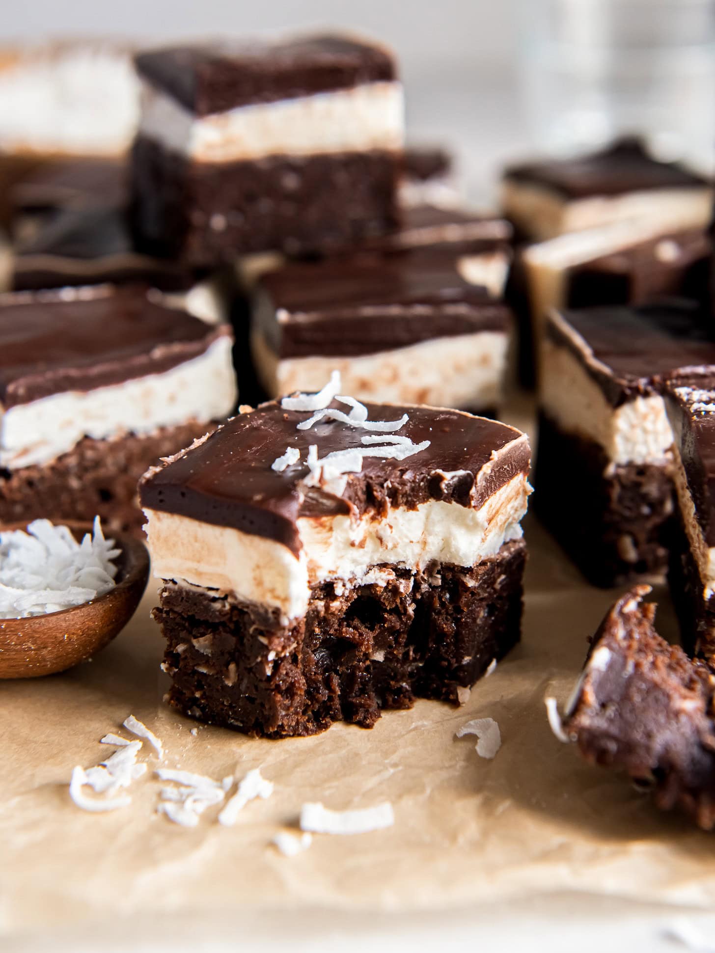 Coconut brownies with a bite taken out of one.