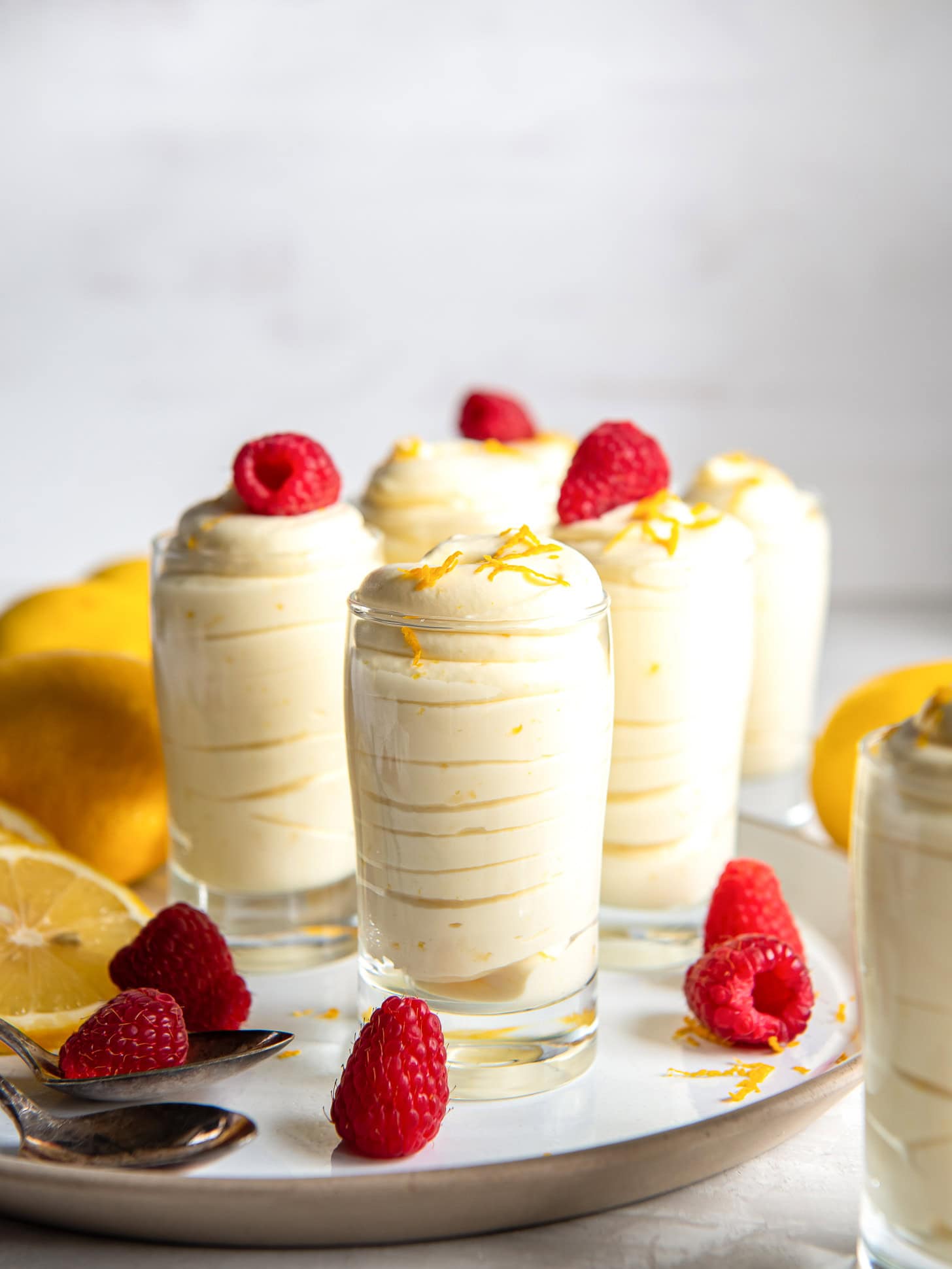 Lemon mouse topped with fresh raspberries.