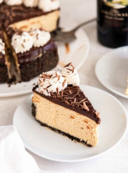 Slice of Irish cream cheesecake on a white plate.