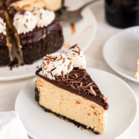 Slice of Irish cream cheesecake on a white plate.