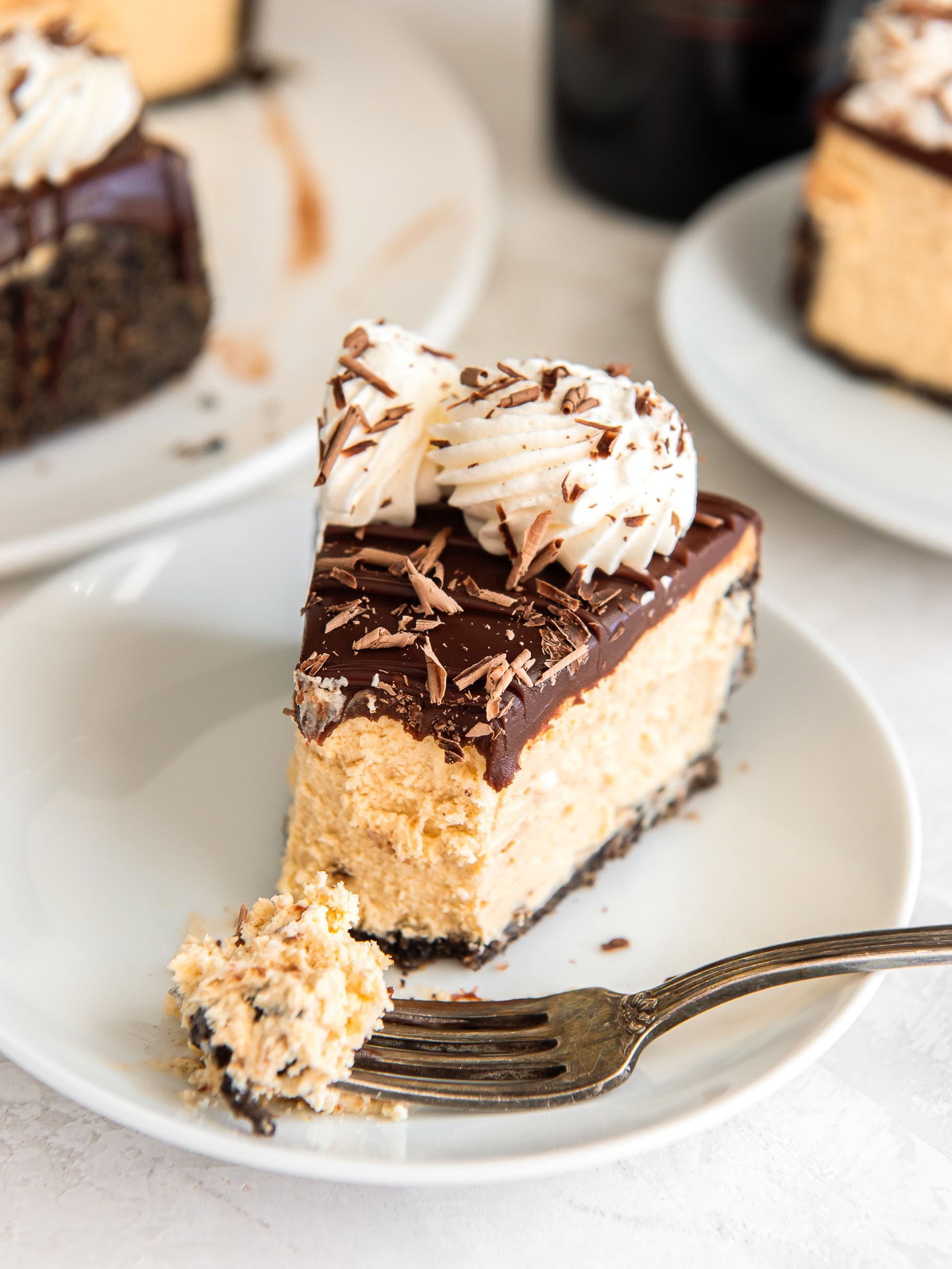 A slice of Irish cream cheesecake with a forkful taken out.