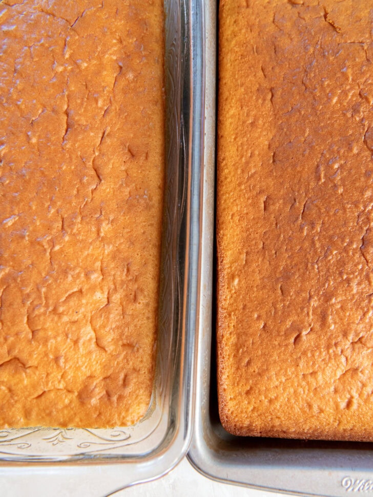 Showing one cake baked in a glass pan and one baked in a metal pan.