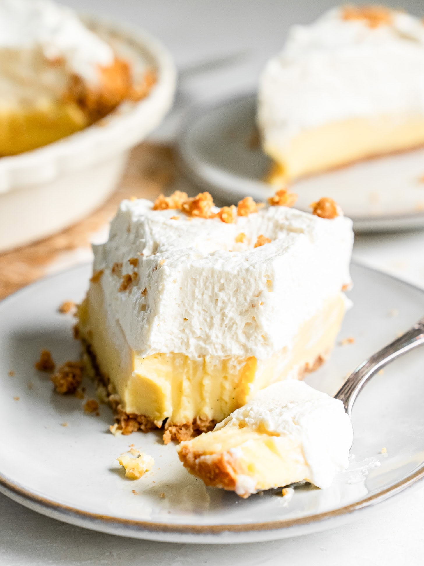 Vanilla cream pie with a forkful taken out.