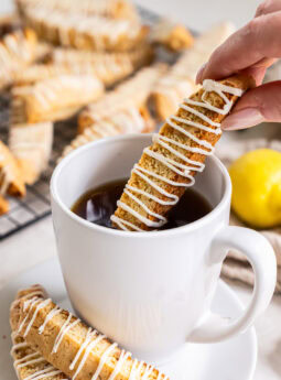 Lemon biscotti dipped into a cup of coffee.