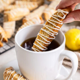 Lemon biscotti dipped into a cup of coffee.