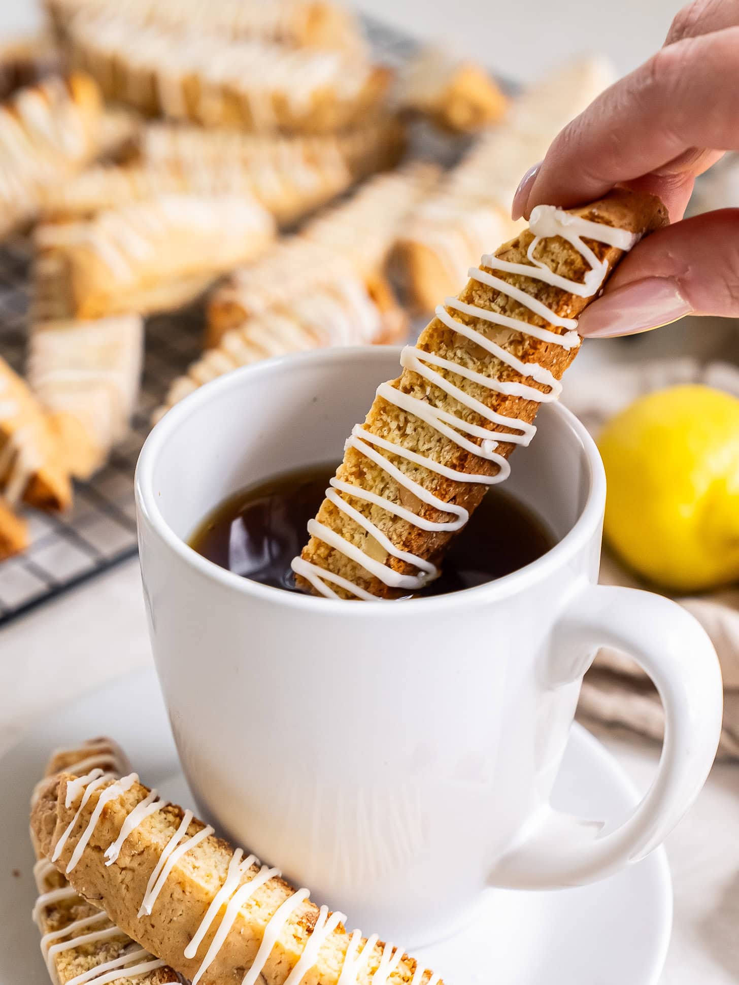 Lemon biscotti dipped into a cup of coffee.