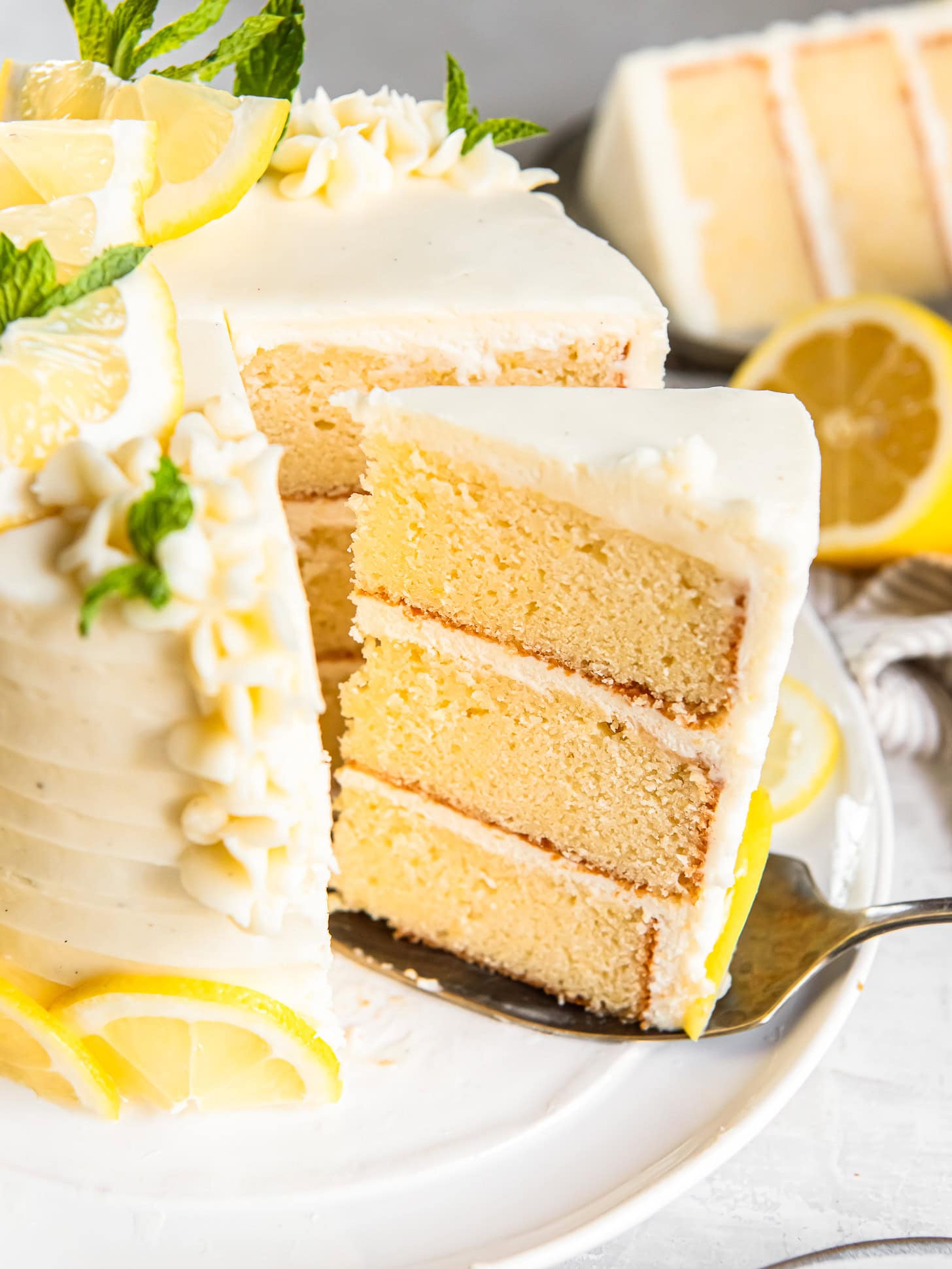 Serving a lemon layer off a cake plate.