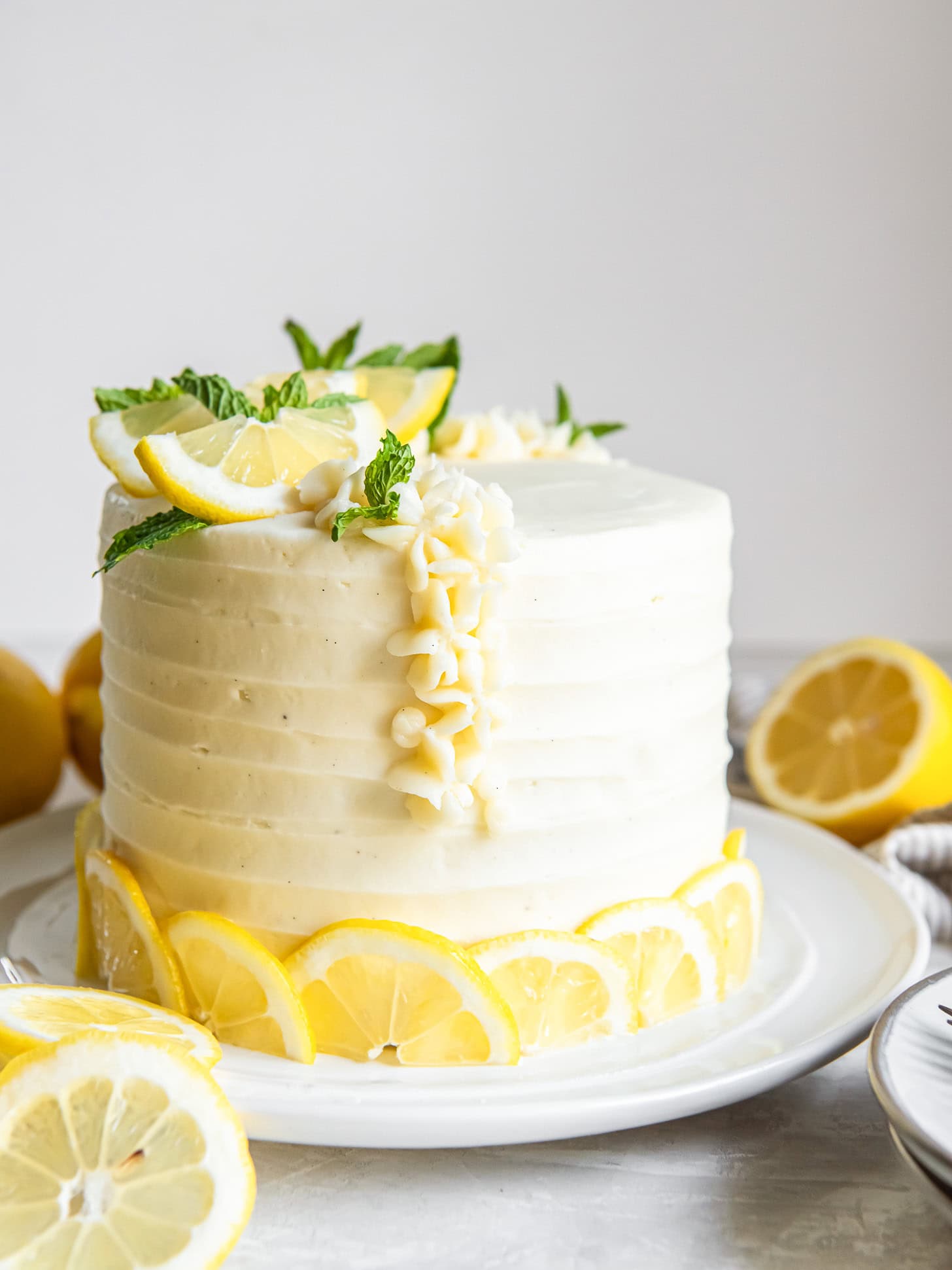 Lemon cake garnished with fresh lemons.