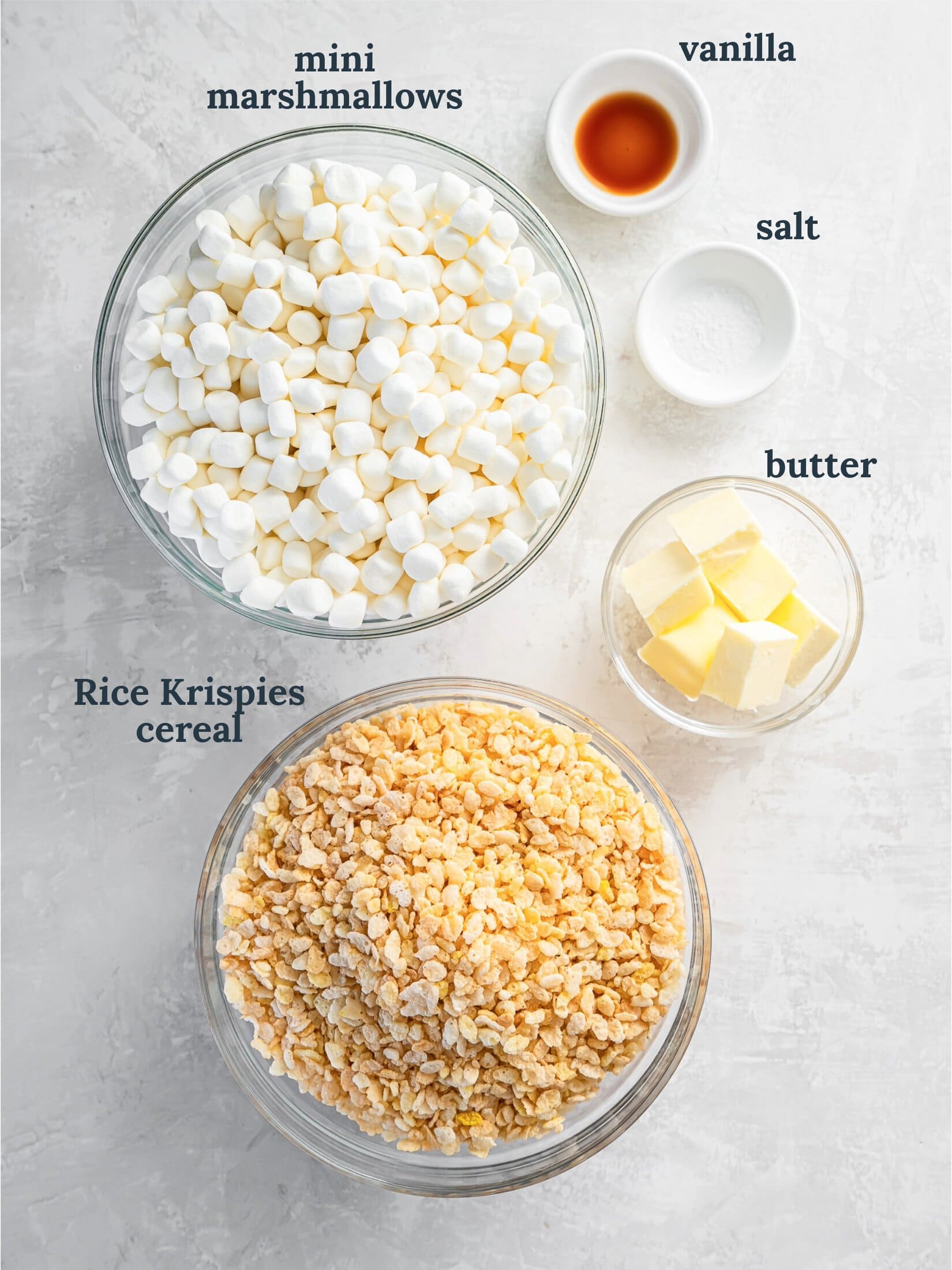 Bowls with marshmallows, Rice Krispies, butter and vanilla.
