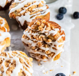 Mixed berry muffins topped with streusel and glaze.