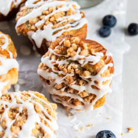 Mixed berry muffins topped with streusel and glaze.