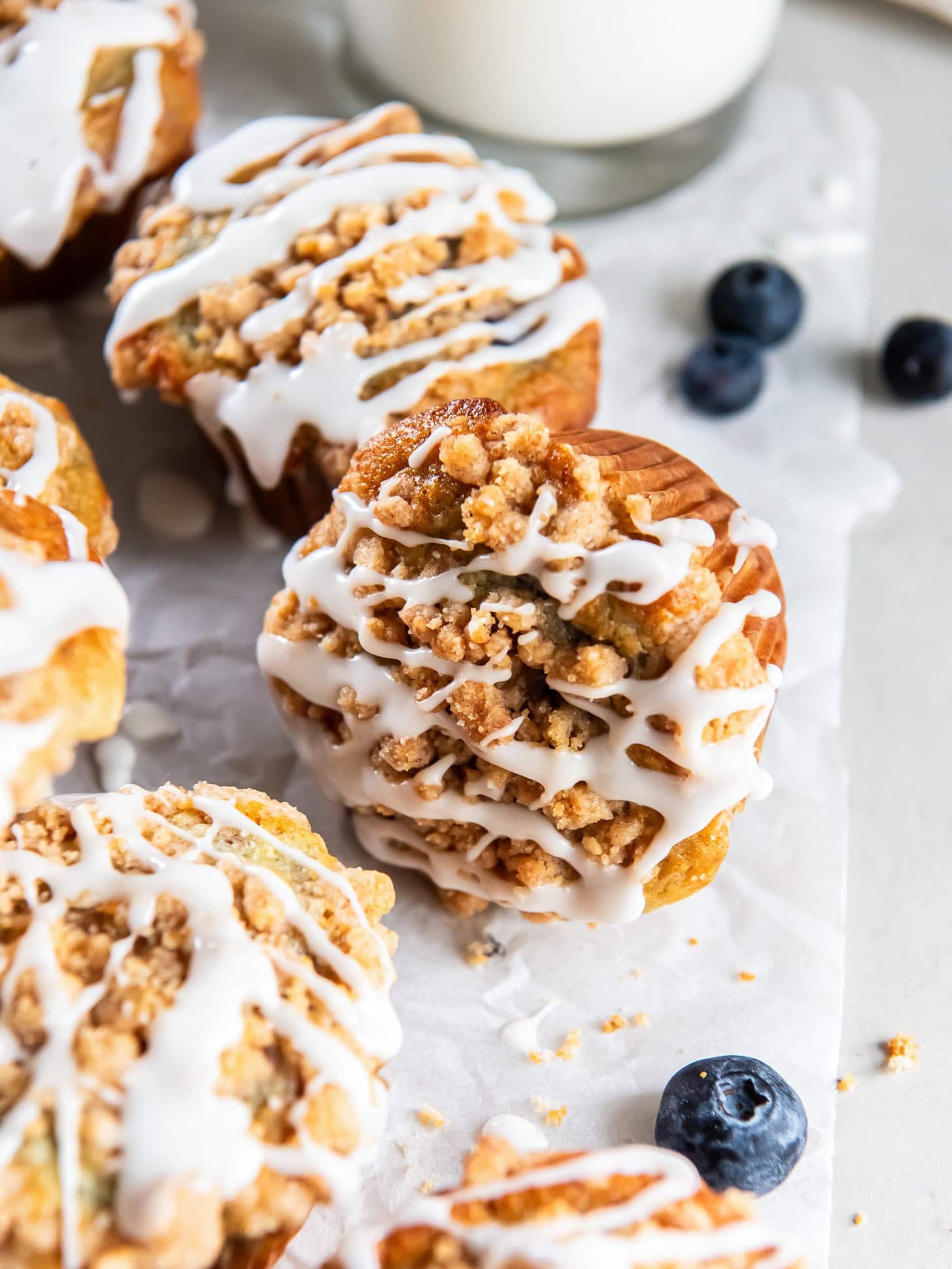Mixed berry muffins topped with streusel and glaze.