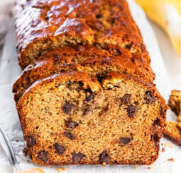 Sliced loaf of peanut butter banana bread with chocolate chips.