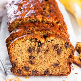 Sliced loaf of peanut butter banana bread with chocolate chips.