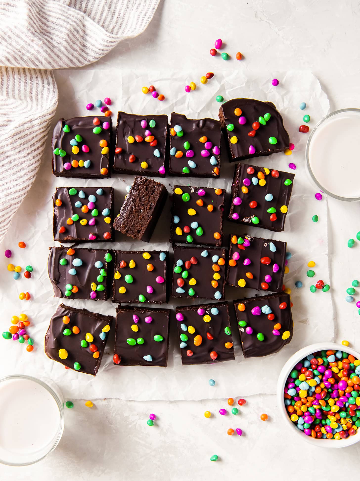 Cosmic brownies cut into squares and topped with candy sprinkles.