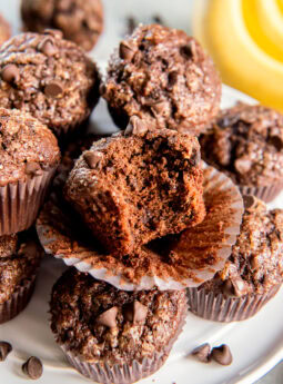 Bite taken out of a double chocolate banana muffin.