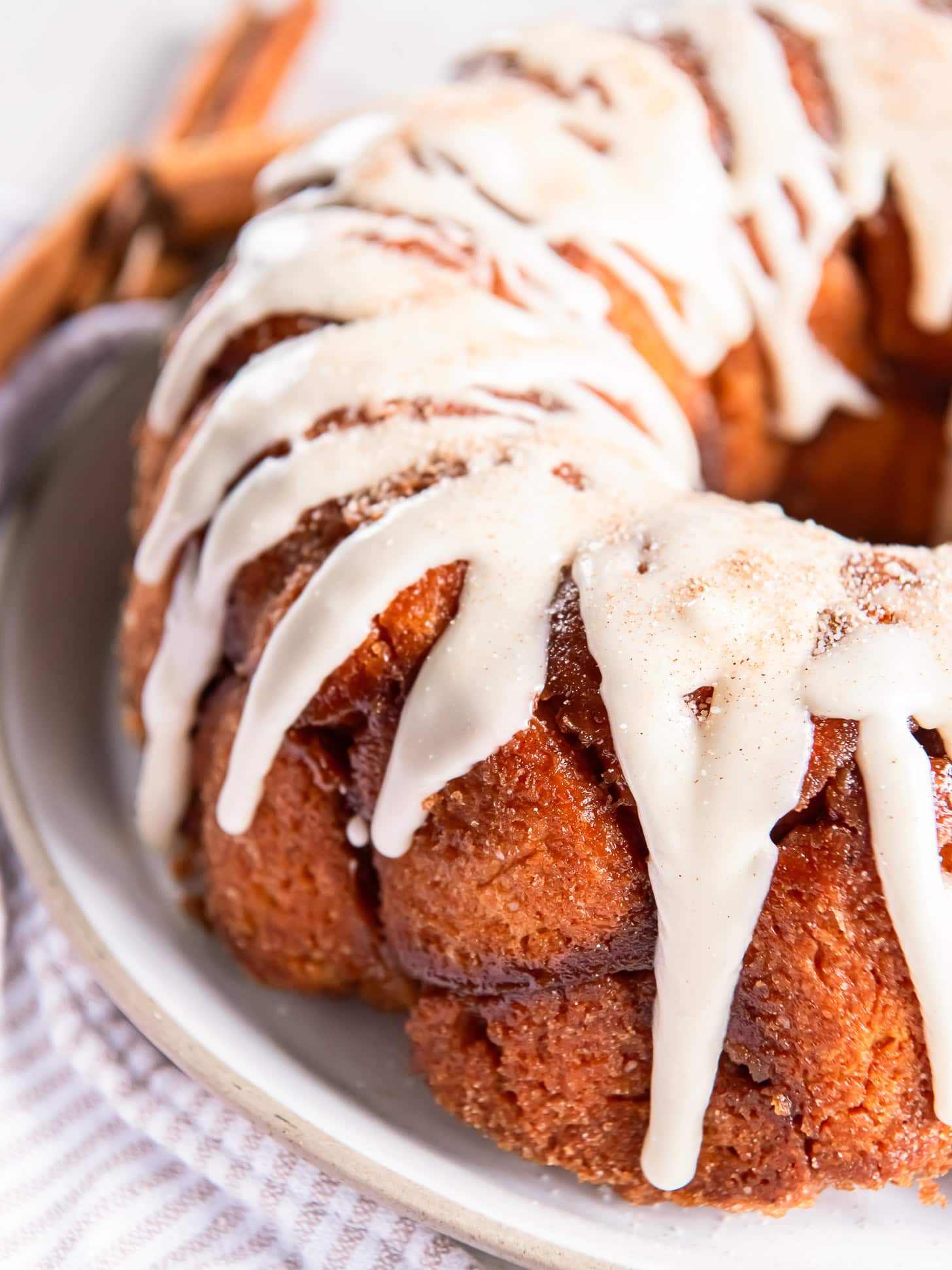 Round monkey bread with vanilla glaze drizzled over the top.