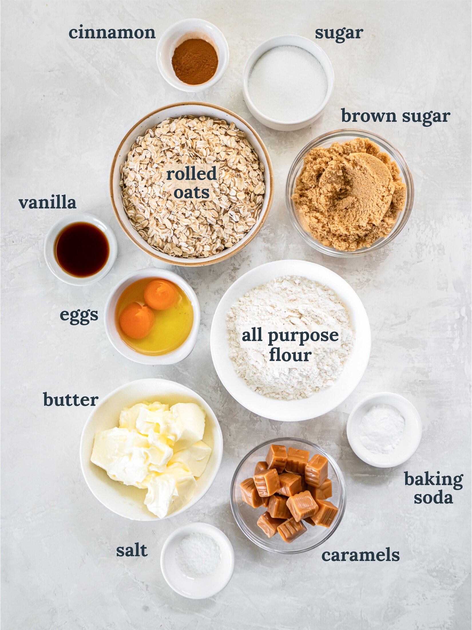 Bowls with oats, sugar, eggs, flour and vanilla.