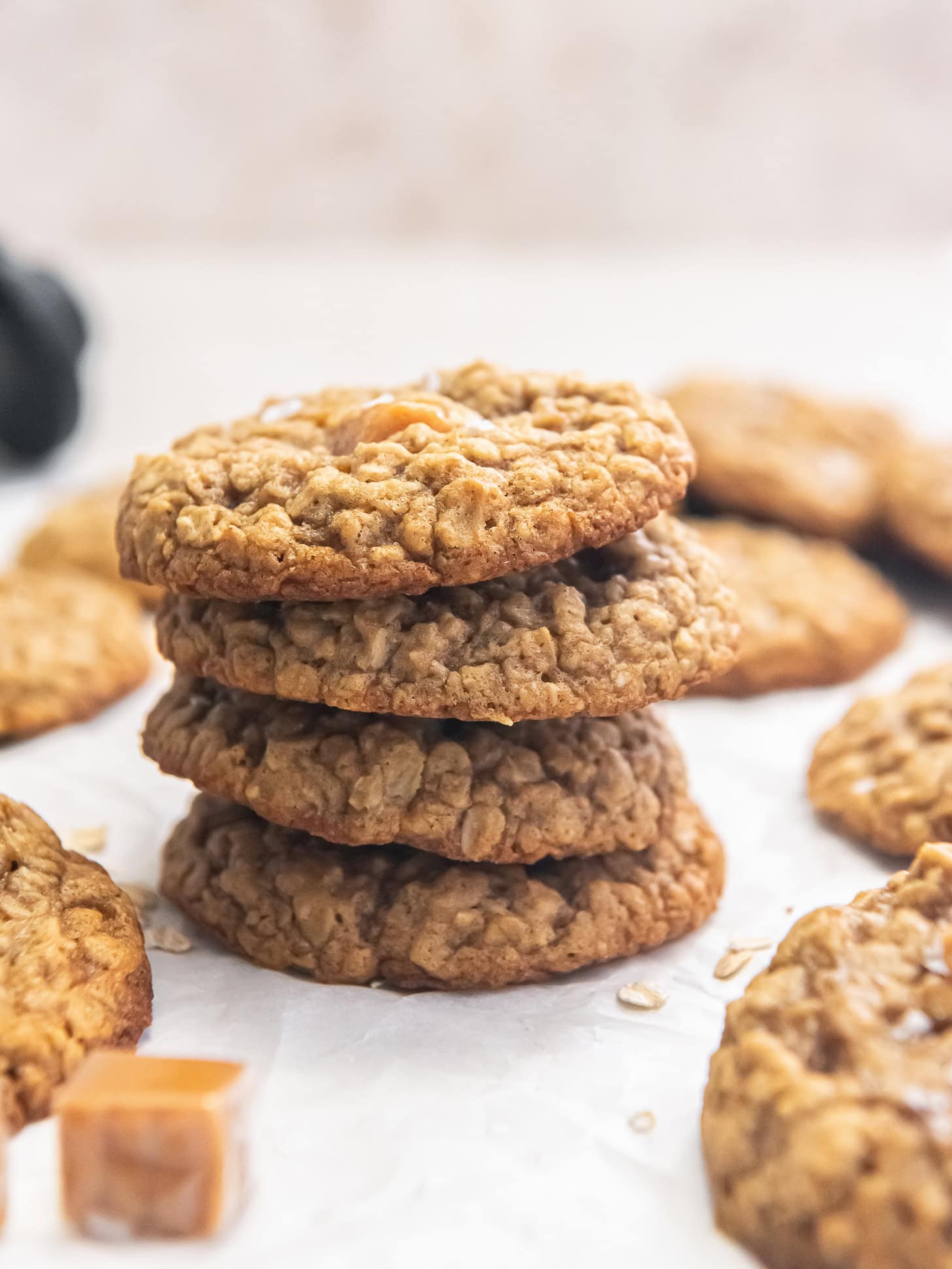 Four caramel oatmeal cookies stacked.