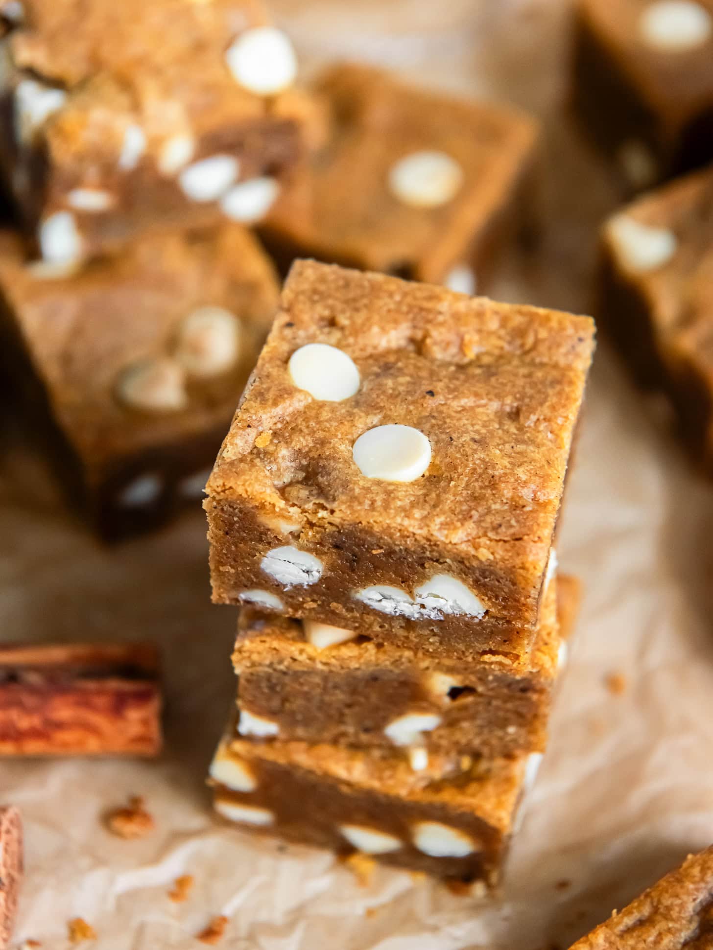 Stacked pumpkin blondies with white chocolate chips.