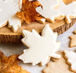 Maple leaf sugar cookies decorated with a white icing.