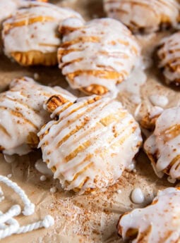 Pumpkin hand pies drizzled with glaze.