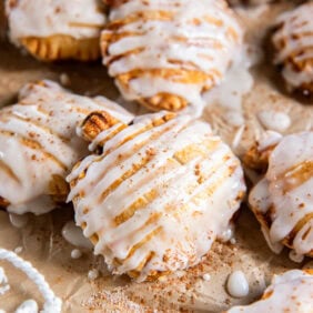 Pumpkin hand pies drizzled with glaze.